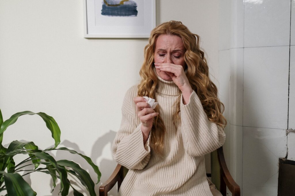 a woman suffering from an allergy attack