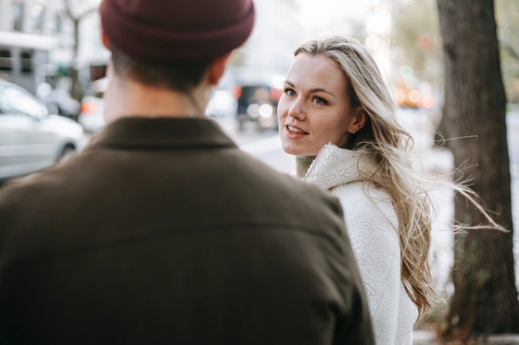 A young woman talking to a man on the street